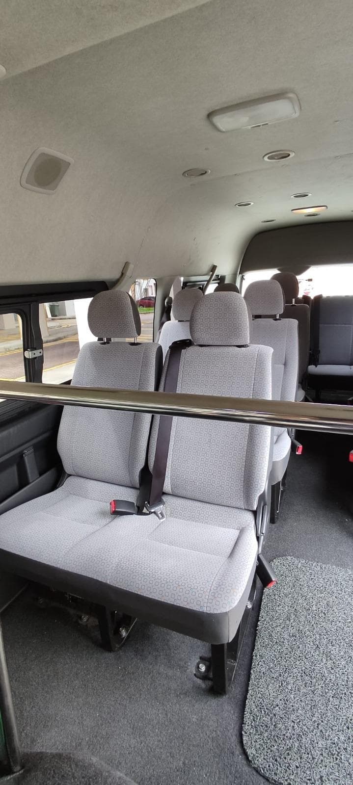 Spacious fabric seating inside Mesa Travels 13-seater maxi cab